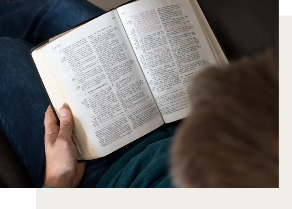 Person reading an open Bible